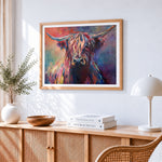Colourful impasto highland cow cross stitch artwork displayed on wall as home decor