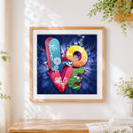 Finished colourful "love" typography cross stitch artwork displayed
