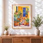 Finished colourful mexican courtyard with cacti cross stitch artwork displayed