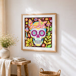 Colourful mexican sugar skull with butterfly cross stitch artwork displayed on wall as home decor