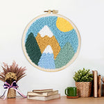 Finished colourful mountain landscape with sun artwork displayed on a wall