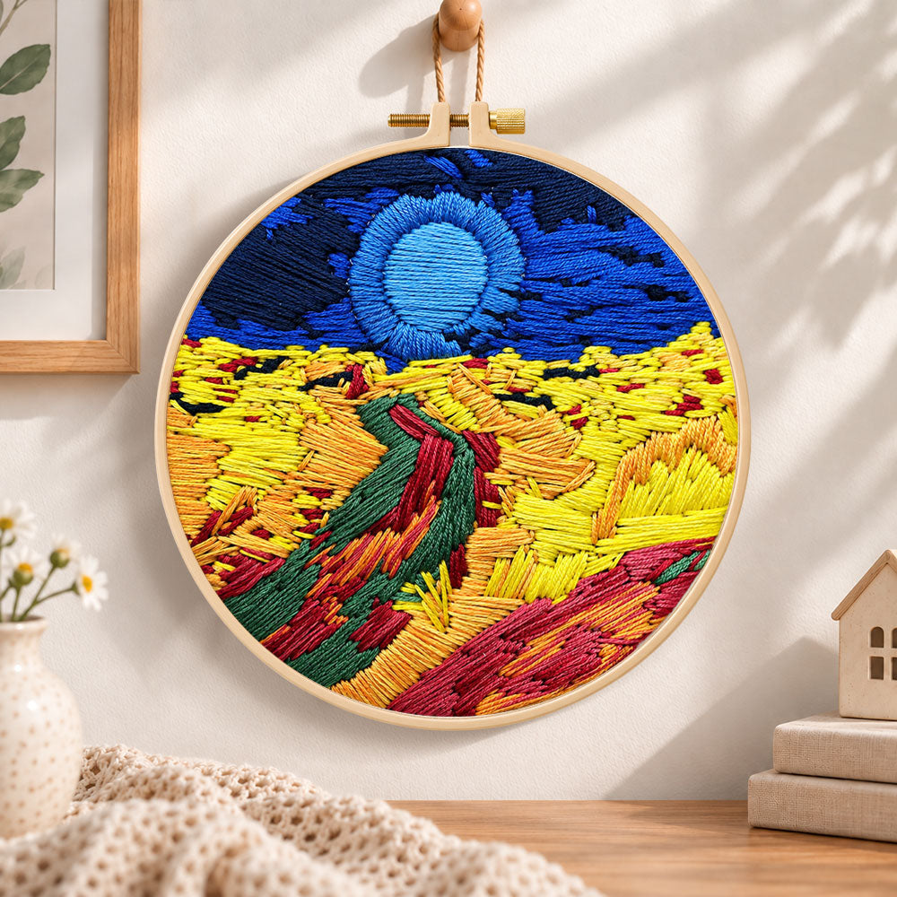 Colourful mountain sunset embroidery hoop wall art displayed as warm and cozy handmade home decor