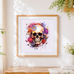 Finished colourful paint splatter floral skull cross stitch artwork displayed