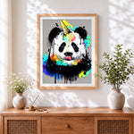 Finished colourful panda with a unicorn horn cross stitch artwork displayed