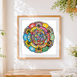 Finished colourful patchwork style mandala cross stitch artwork displayed