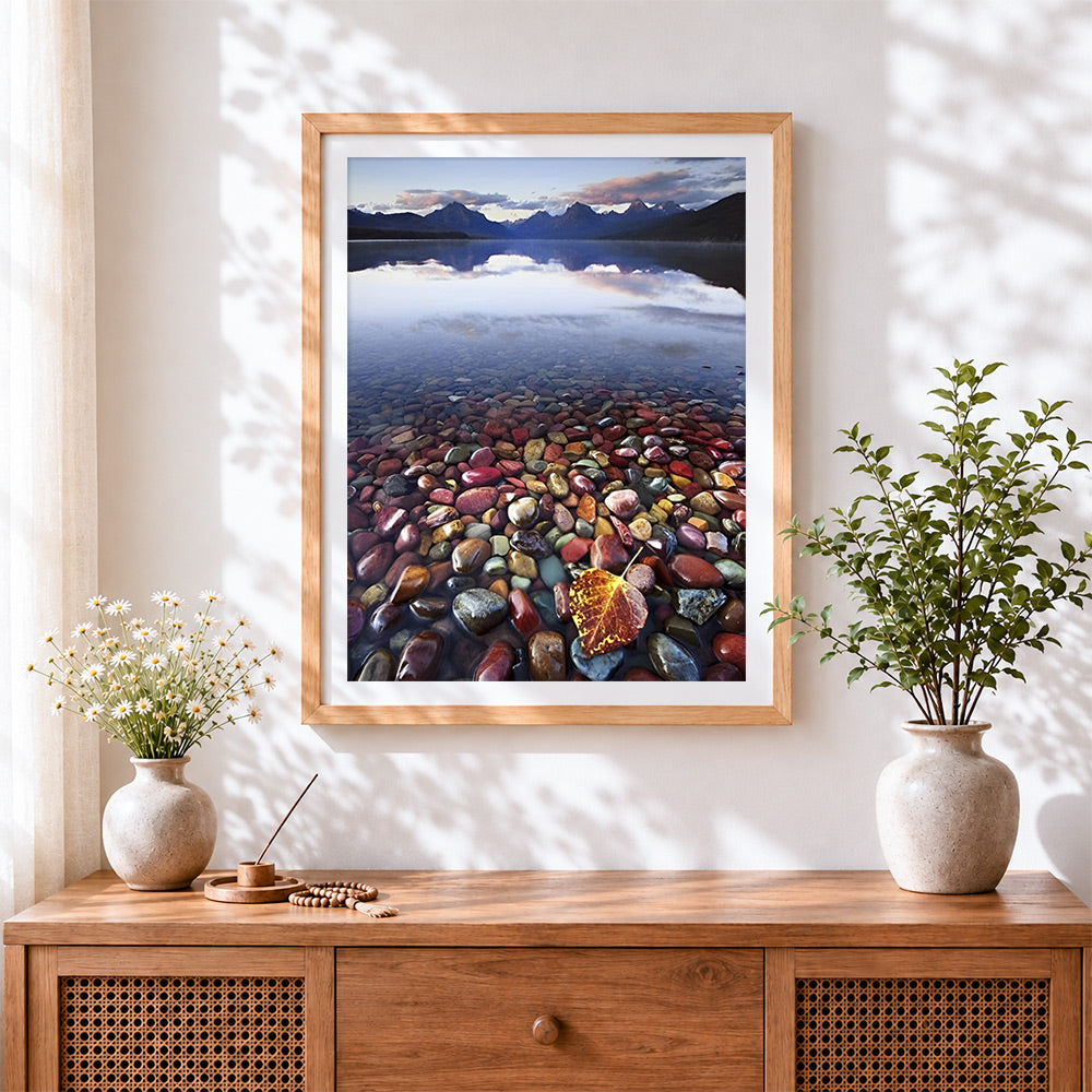 Finished colourful pebbles and autumn leaf in clear water cross stitch artwork displayed