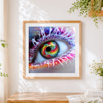 Finished colourful rainbow eye close up cross stitch artwork displayed