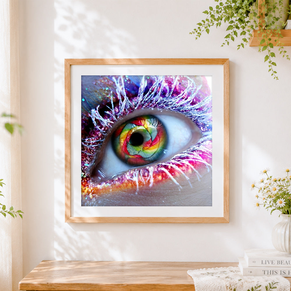 Finished colourful rainbow eye close up cross stitch artwork displayed