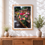 Finished colourful roses and rustic fence cross stitch artwork displayed