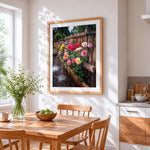 Colourful roses and rustic fence cross stitch artwork displayed on wall as home decor