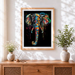 Finished colourful splatter elephant on black background cross stitch artwork displayed