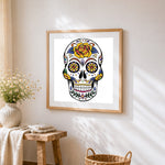 Colourful sugar skull with yellow flowers cross stitch artwork displayed on wall as home decor