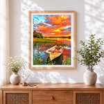 Finished colourful sunset boat cross stitch artwork displayed