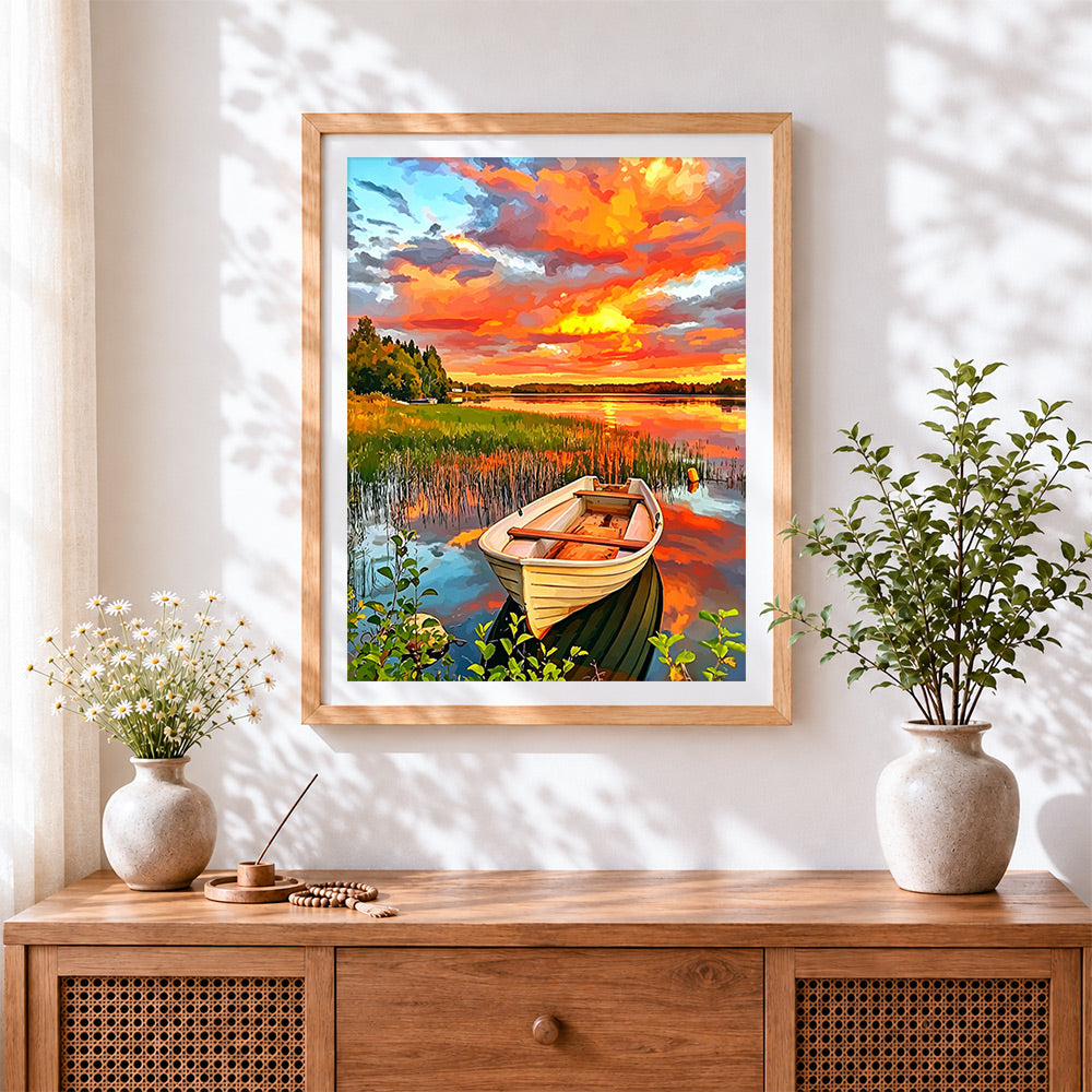 Finished colourful sunset boat cross stitch artwork displayed