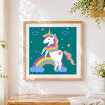 Finished colourful unicorn on a rainbow cross stitch artwork displayed
