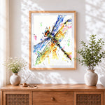 Finished colourful watercolour dragonfly cross stitch artwork displayed