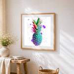 Colourful watercolour pineapple cross stitch artwork displayed on wall as home decor