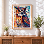 Finished colourful watercolour splash owl cross stitch artwork displayed