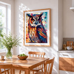 Colourful watercolour splash owl cross stitch artwork displayed on wall as home decor