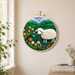 Colourful wildflower meadow with a sheep needle felt wall art displayed in a bright home interior