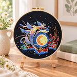 Cosmic betta fish embroidery kit finished hoop displayed on a wooden stand as cosy tabletop decor
