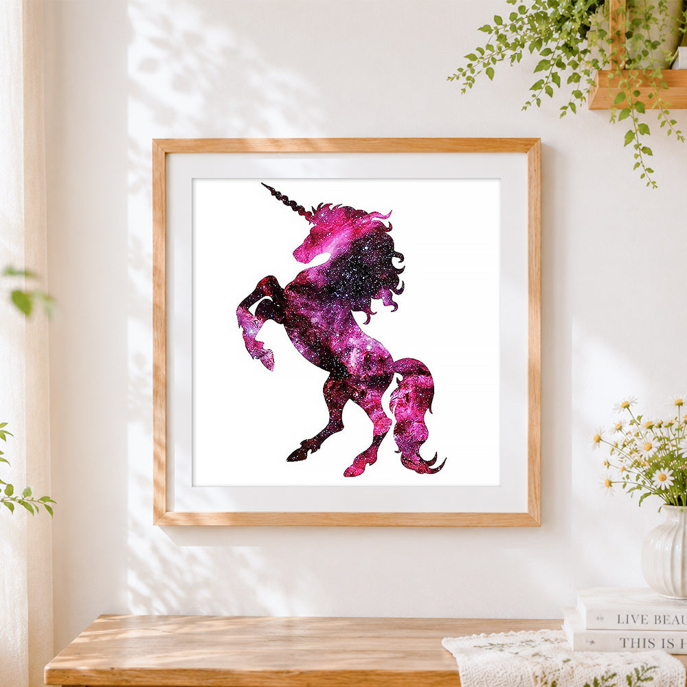 Finished cosmic pink unicorn silhouette cross stitch artwork displayed