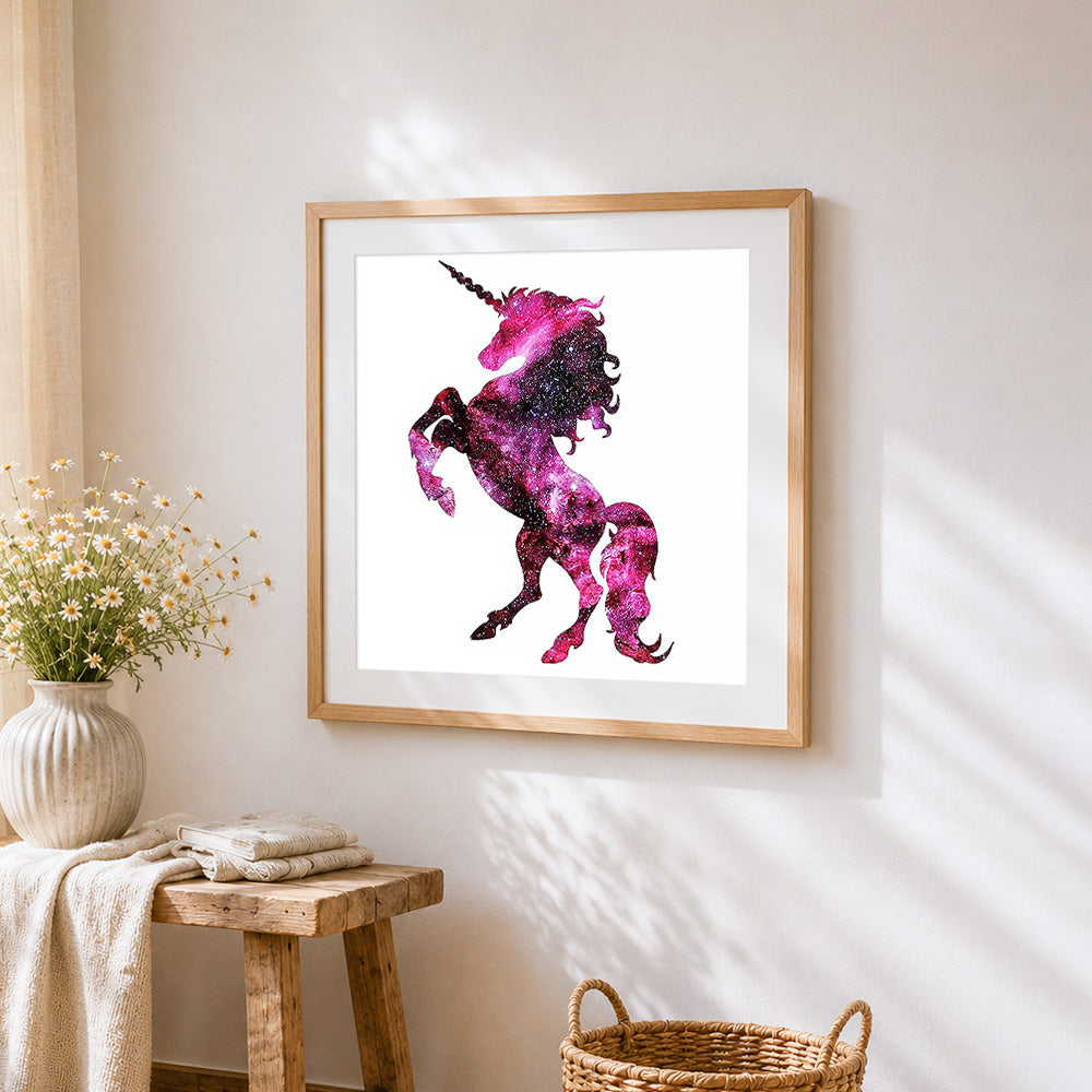 Cosmic pink unicorn silhouette cross stitch artwork displayed on wall as home decor
