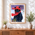 Finished cosy black cat in red scarf cross stitch artwork displayed