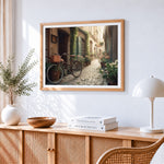 Cosy european alleyway and bicycle paint by numbers artwork displayed on wall as home decor
