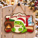 Cosy frog holiday paint by numbers door hanger on a garden gate
