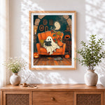 Finished cosy ghost reading in armchair cross stitch artwork displayed