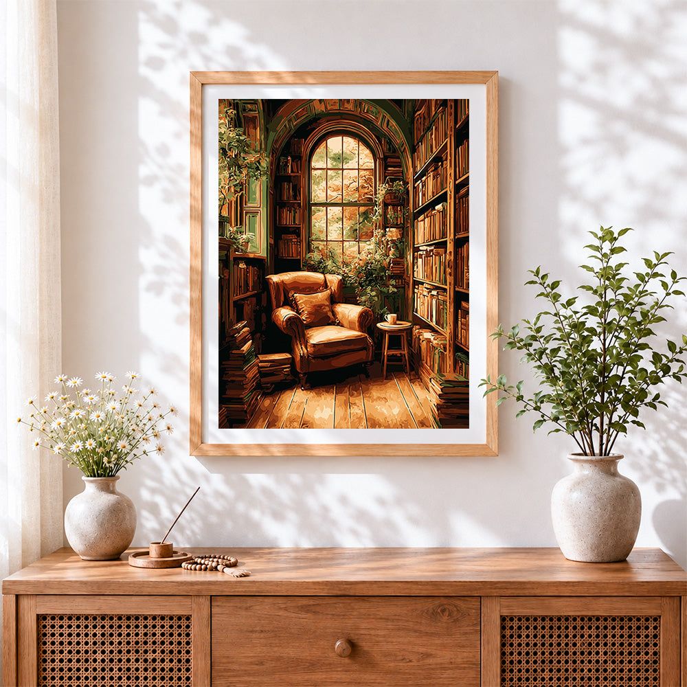 Finished cosy leather armchair library cross stitch artwork displayed