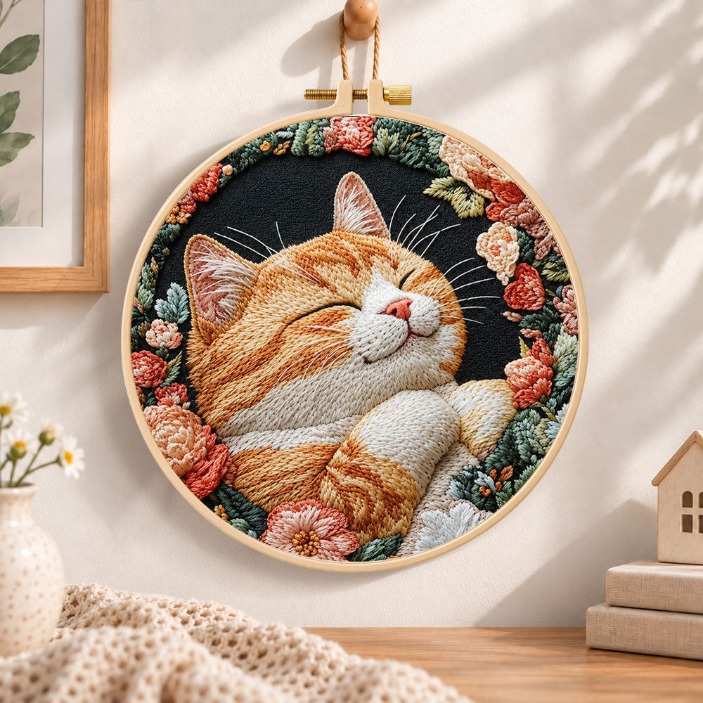 Cosy napping orange cat embroidery hoop wall art displayed as warm and cosy handmade home decor
