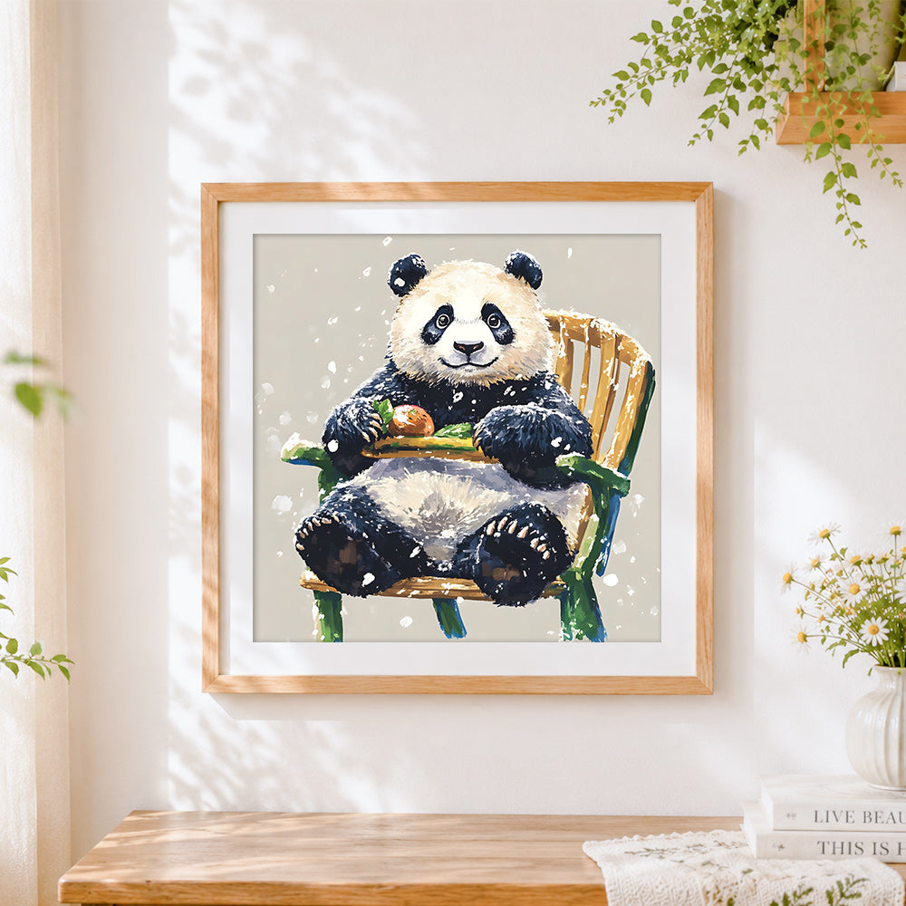 Finished cosy panda sitting on a chair in the snow cross stitch artwork displayed