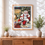 Finished cosy santa relaxing with a hot drink cross stitch artwork displayed