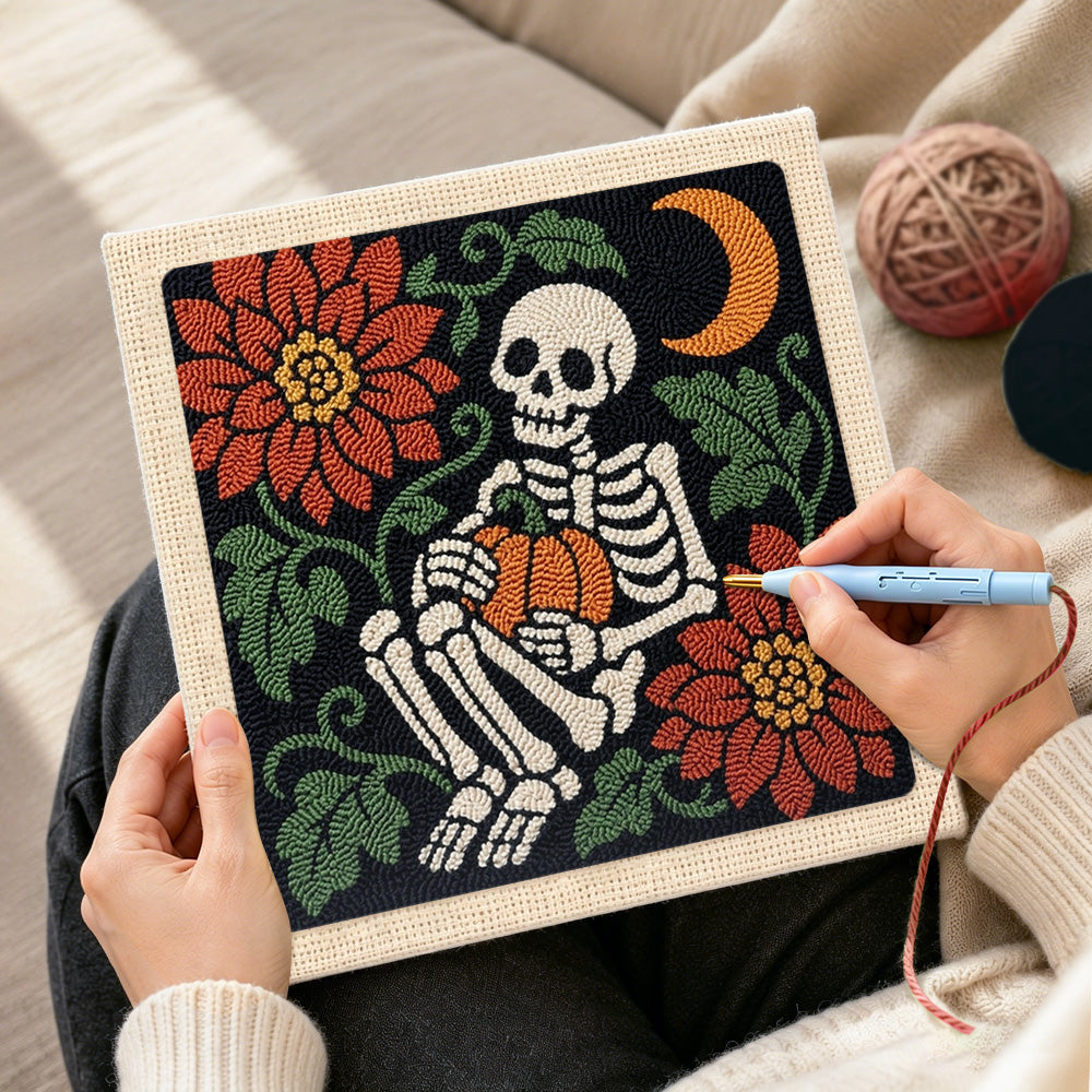 Creating handmade cosy skeleton holding pumpkin punch needle artwork