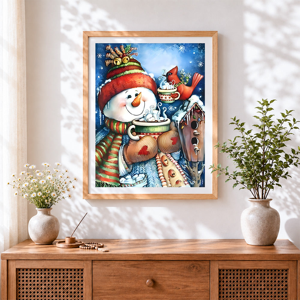 Finished cosy snowman drinking hot cocoa cross stitch artwork displayed