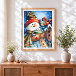Finished cosy snowman drinking hot cocoa cross stitch artwork displayed