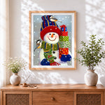 Finished cosy snowman with knitted hat cross stitch artwork displayed