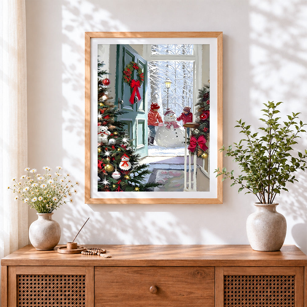Finished cosy view of children building snowman cross stitch artwork displayed