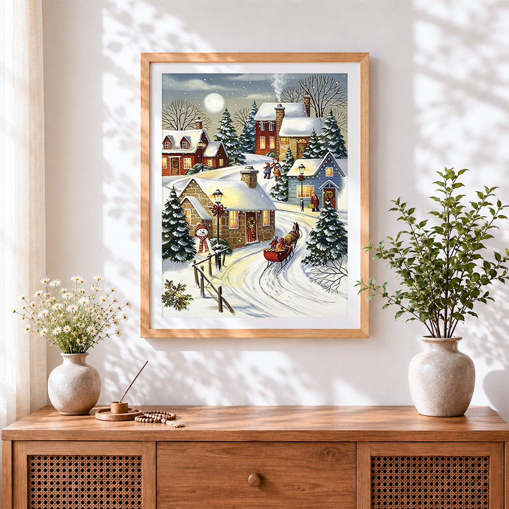 Finished cosy winter sleigh and snowman cross stitch artwork displayed