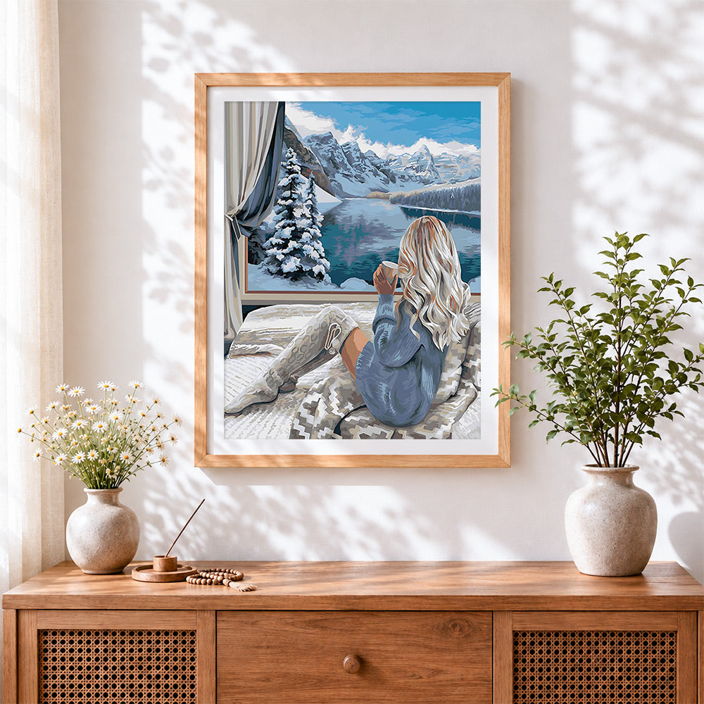 Finished cosy winter window mountain view cross stitch artwork displayed