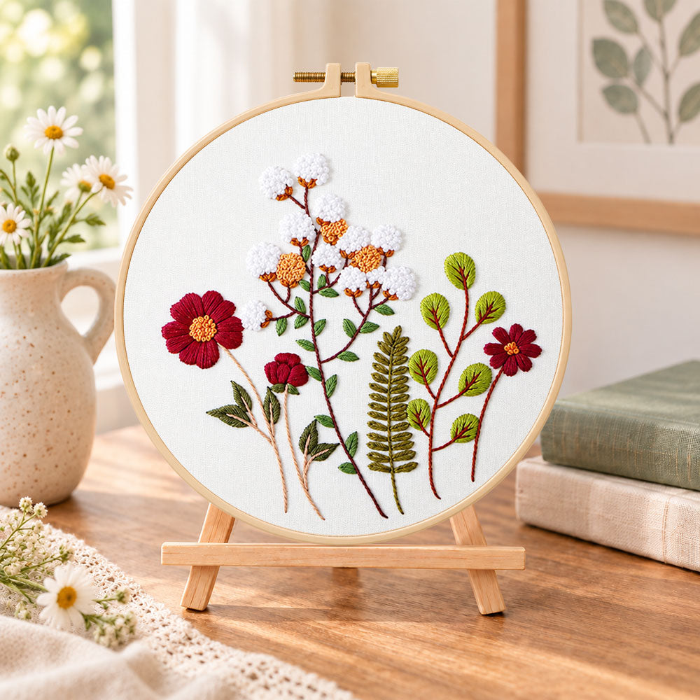 Cotton and burgundy flower arrangement embroidery kit finished hoop displayed on a wooden stand as cosy tabletop decor