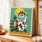 Cowboy ghost with lasso punch needle artwork displayed on a table