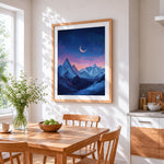 Crescent moon over snowy mountains cross stitch artwork displayed on wall as home decor