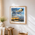 Crystal apple with city sunset reflection cross stitch artwork displayed on wall as home decor