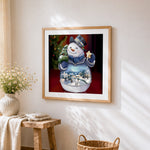 Crystal snowman snow globe cross stitch artwork displayed on wall as home decor