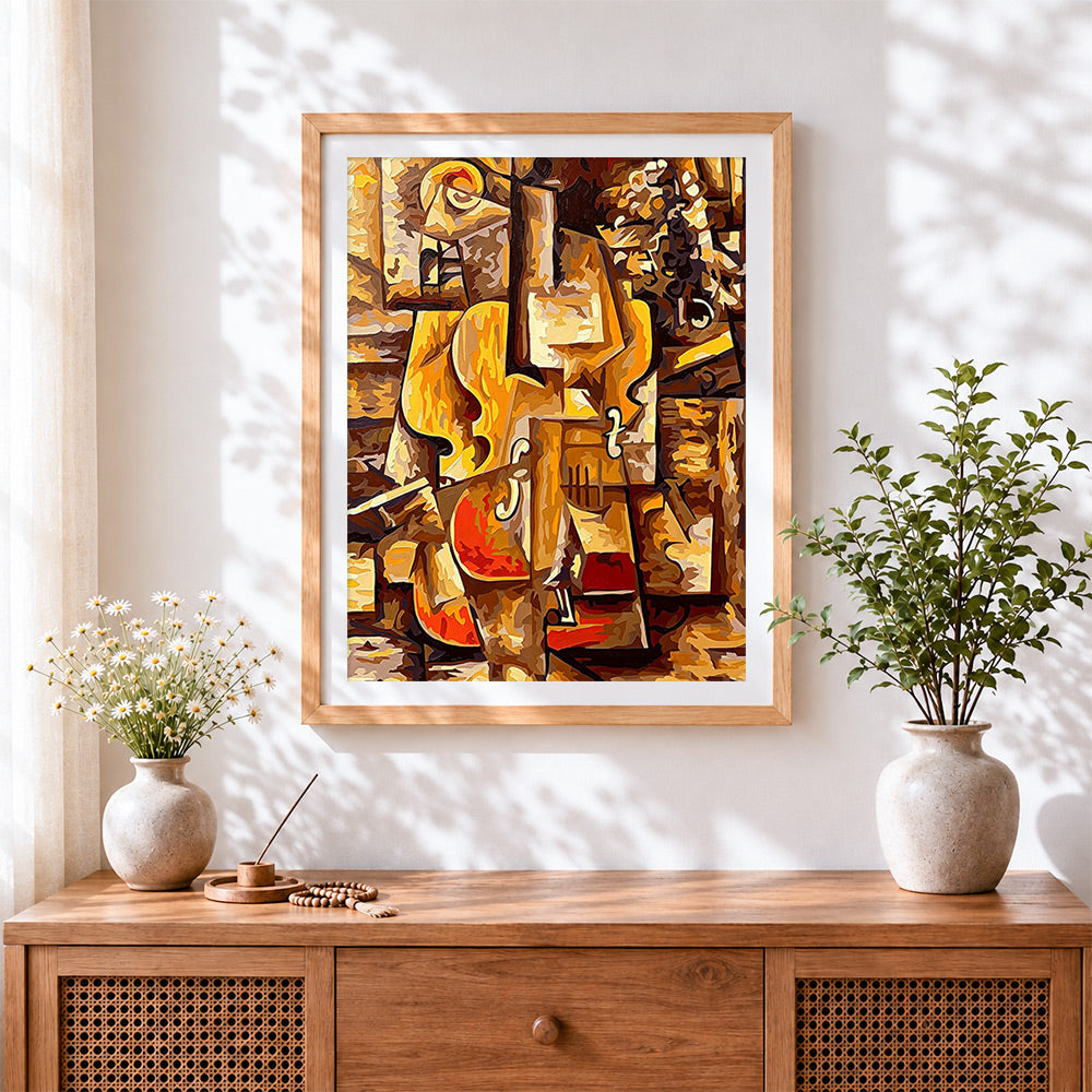 Finished cubist cello cross stitch artwork displayed