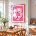 Cuddling kittens with heart cross stitch artwork displayed on wall as home decor