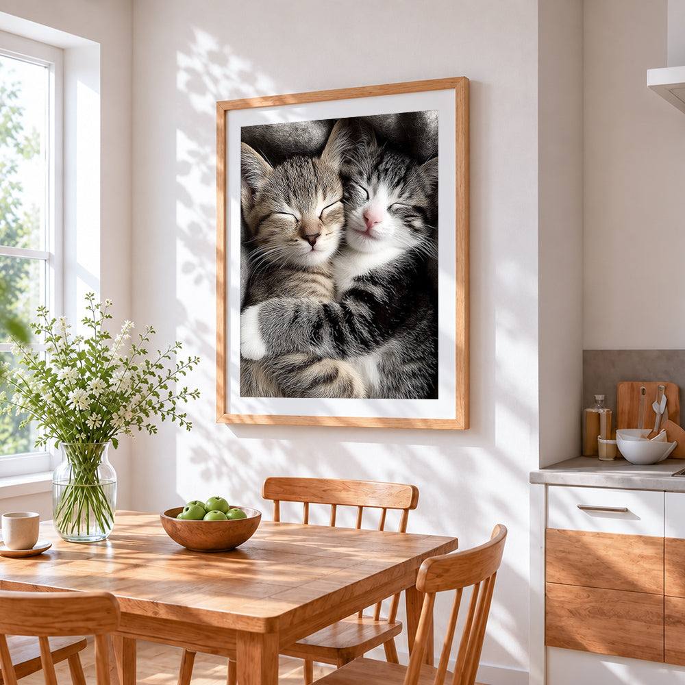 Cuddling sleeping kittens cross stitch artwork displayed on wall as home decor